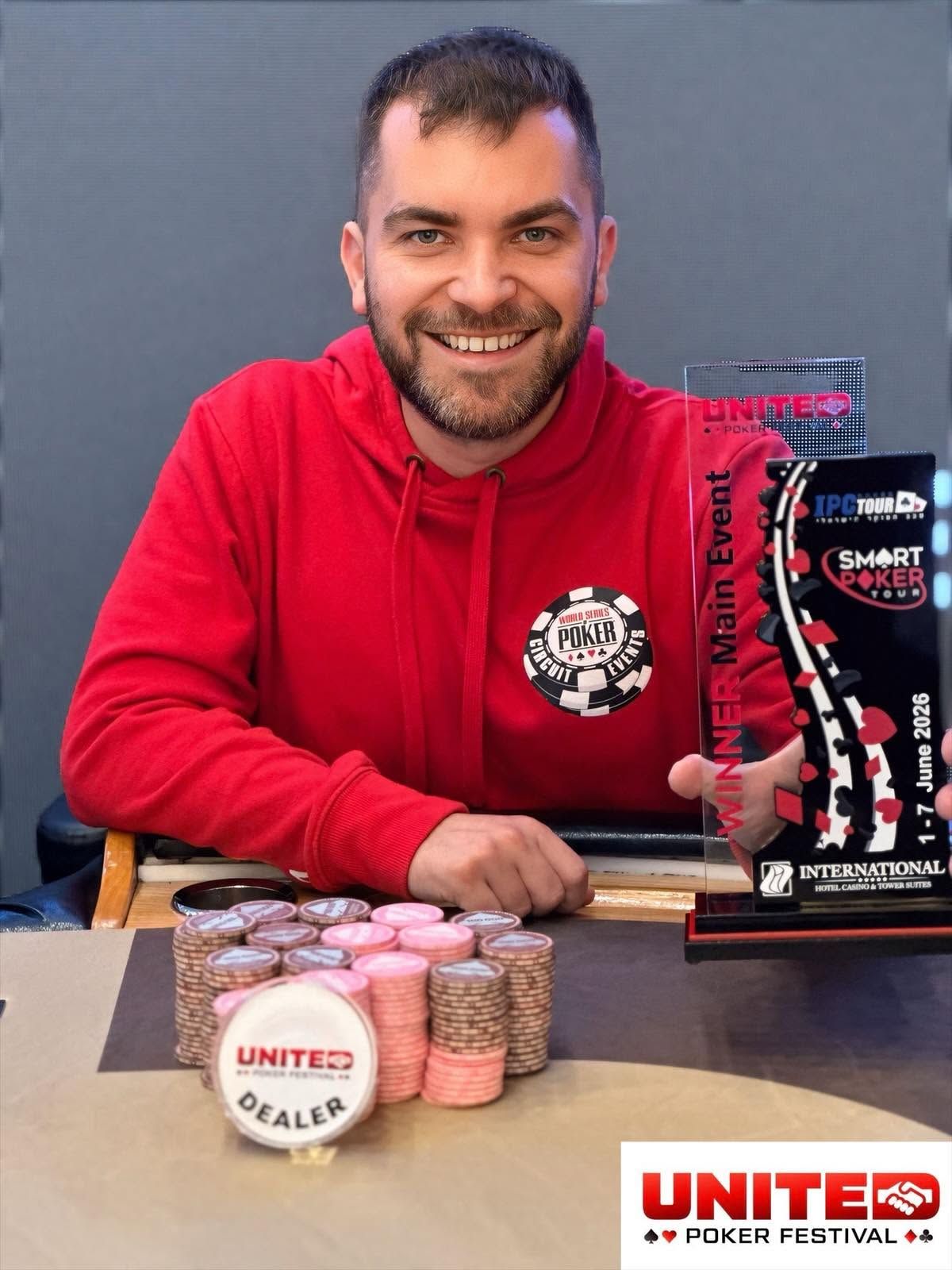 Erik Navratil holding the United Poker Festival #4 Main Event champion trophy